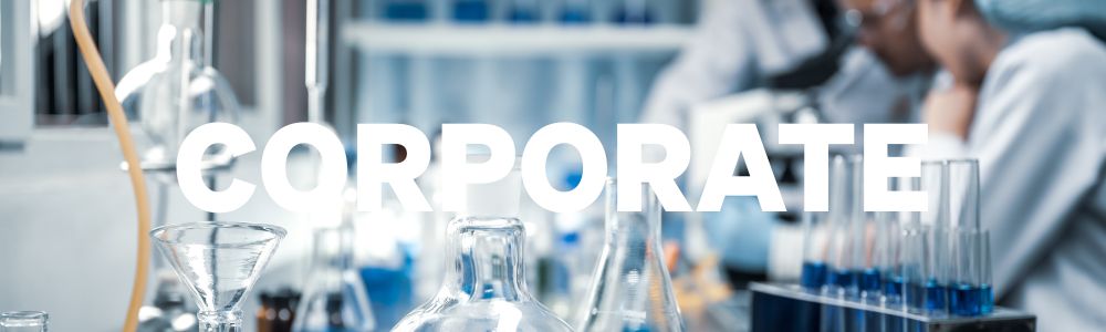 A dropper drops light orange fluid int a tray of test tubes.